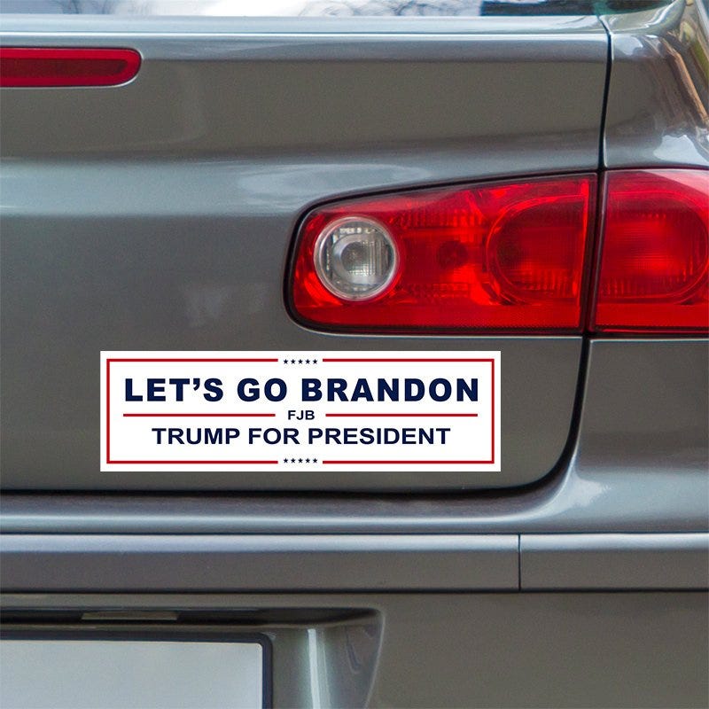 Let's Go Brandon Bumper Sticker below a gray car's tail light