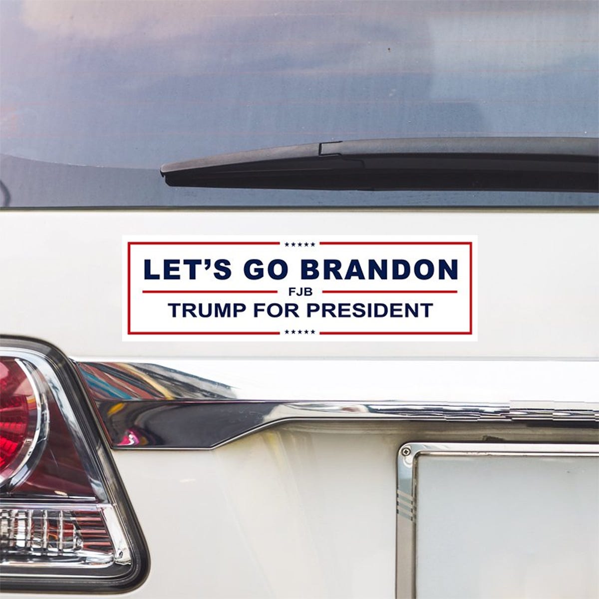 Let's Go Brandon Bumper Sticker above a white car's tail light