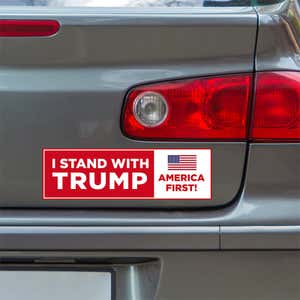 I Stand with Trump Bumper Sticker below a gray car's tail light