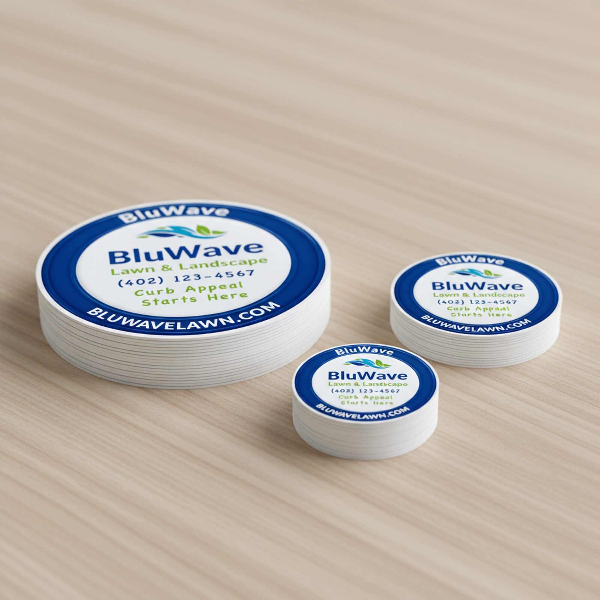 Three stacks of the same custom vinyl sticker in varying sizes