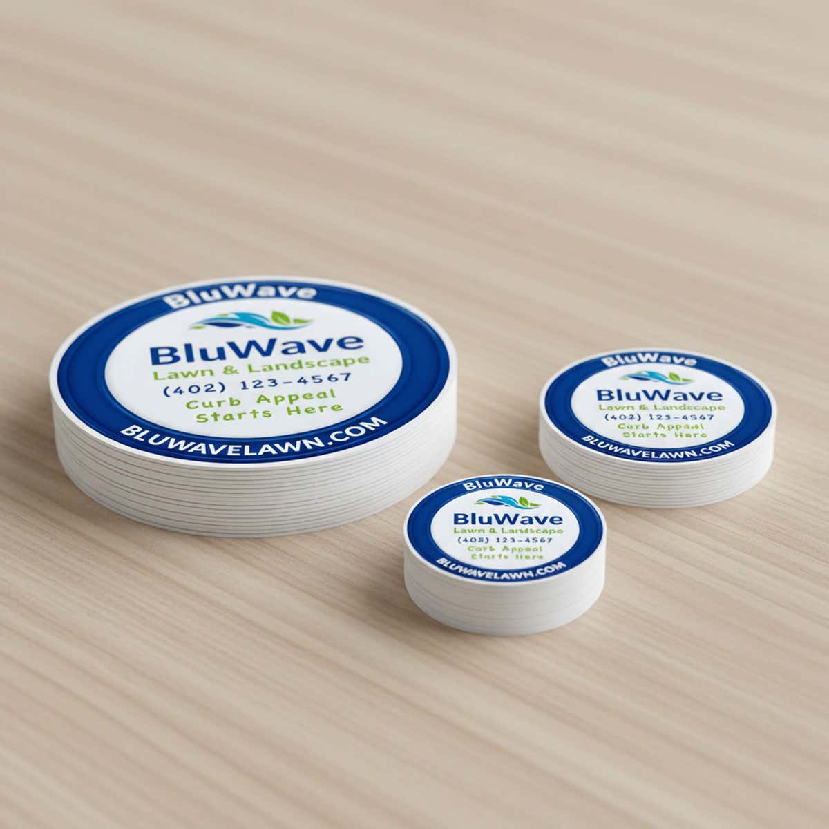 Three stacks of the same custom vinyl sticker in varying sizes