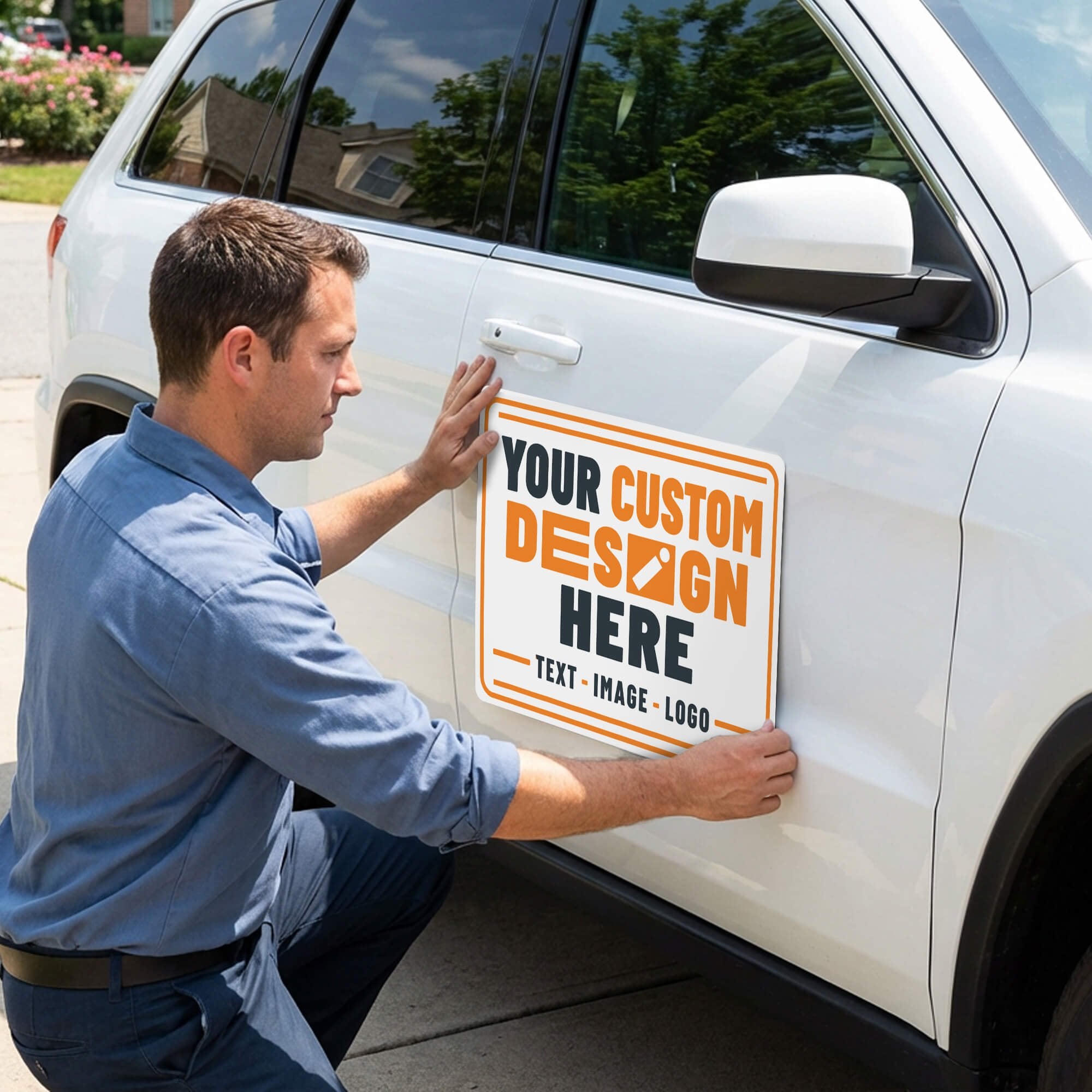A man appling a car magnet to an SUV