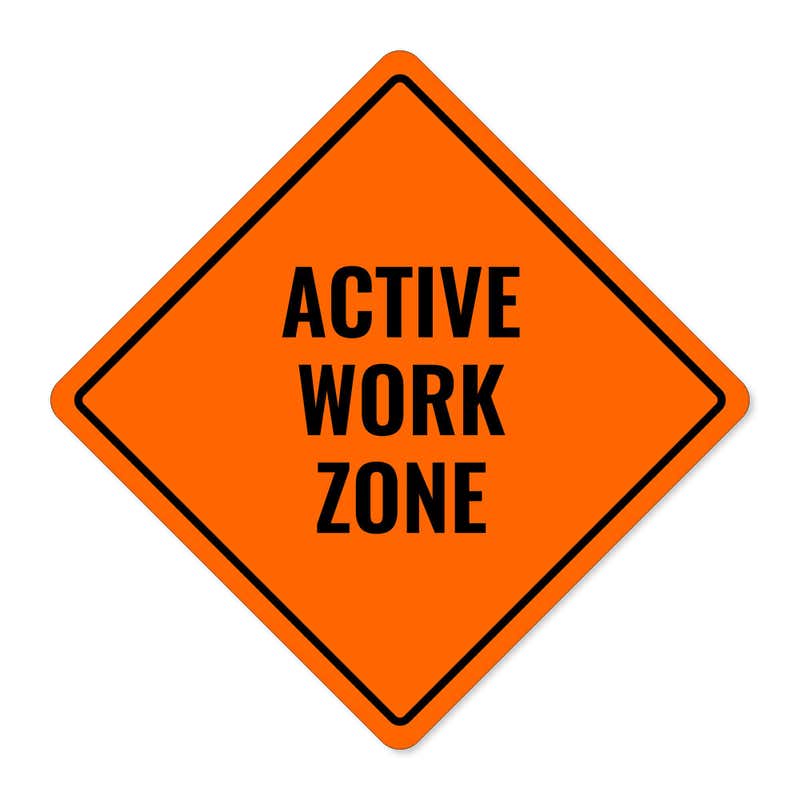 Orange aluminum sign with the message of an active work zone