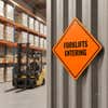 An orange diamond aluminum sign displayed in a warehouse where forklifts are being operated