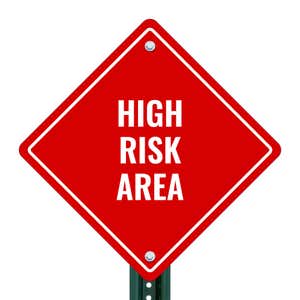 HIGH RISK AREA red aluminum diamond sign on a pole