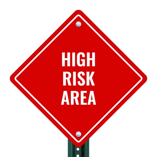 HIGH RISK AREA red aluminum diamond sign on a pole