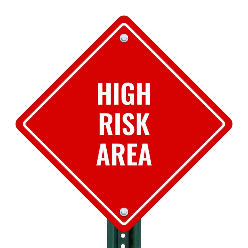 HIGH RISK AREA red aluminum diamond sign on a pole