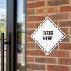 A white diamond aluminum sign for an entrance 