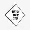 A white diamond aluminum sign with the message WATCH YOUR STEP