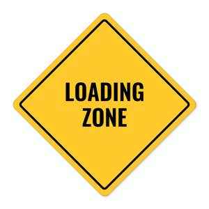 A yellow diamond sign with the message LOADING AREA