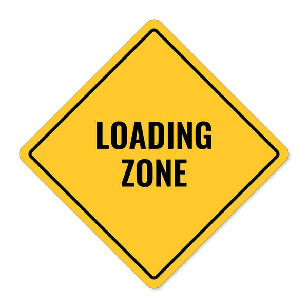 A yellow diamond sign with the message LOADING AREA