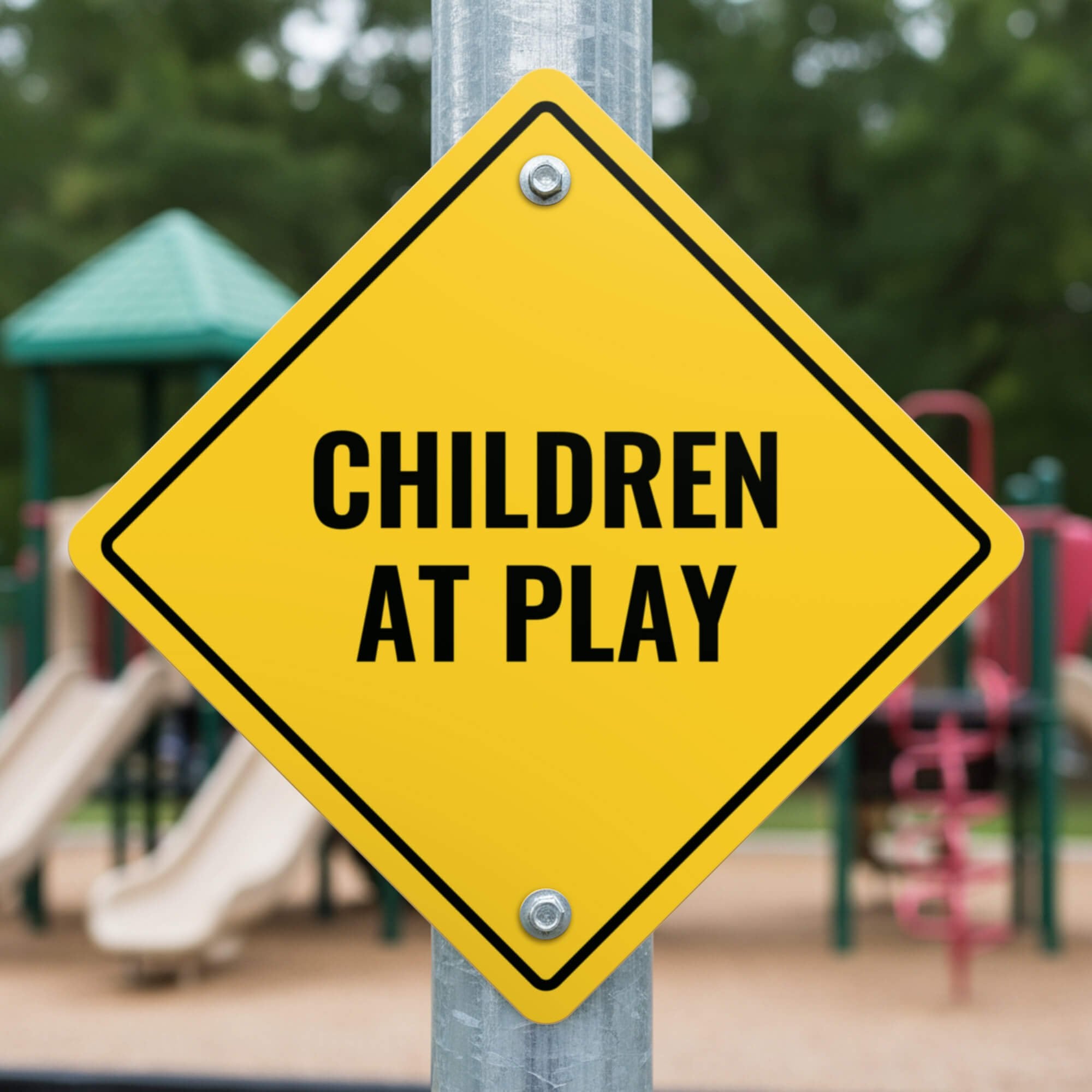 A yellow diamond sign on a post with the message CHILDREN AT PLAY