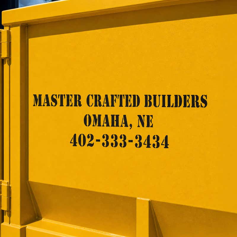 A constructions company's information stenciled onto a container