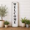 Welcome stenciled onto a white board 