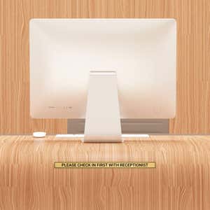 1x16 custom engraved brass sign displayed on a desk