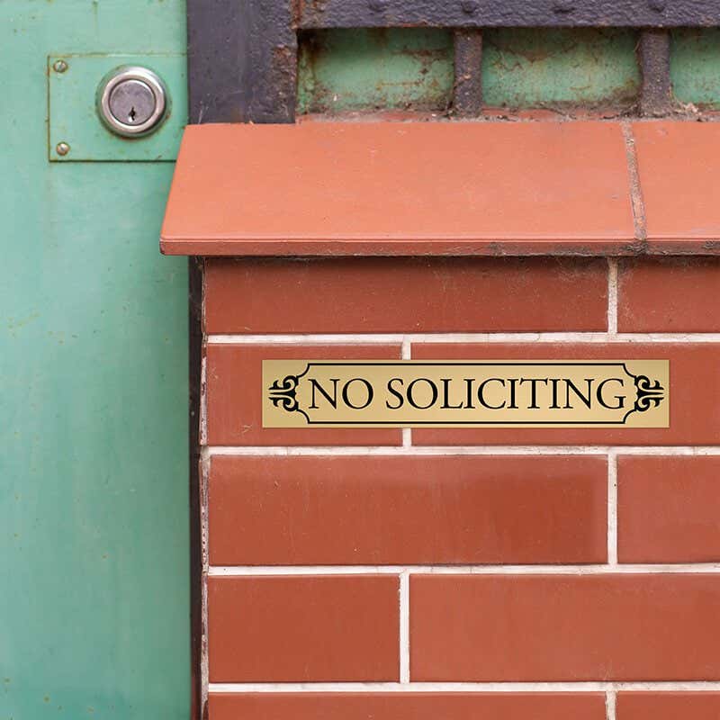 1x6 custom engraved brass sign displayed on brick