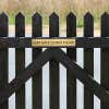 2x12 custom engraved brass sign on a fence
