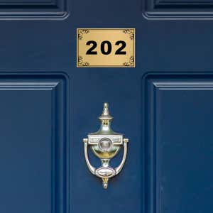 2x3 custom engraved brass sign displayed on a door