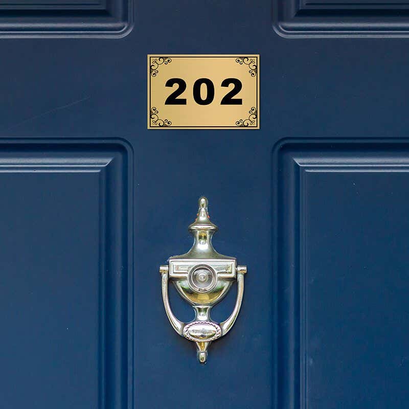 2x3 custom engraved brass sign displayed on a door