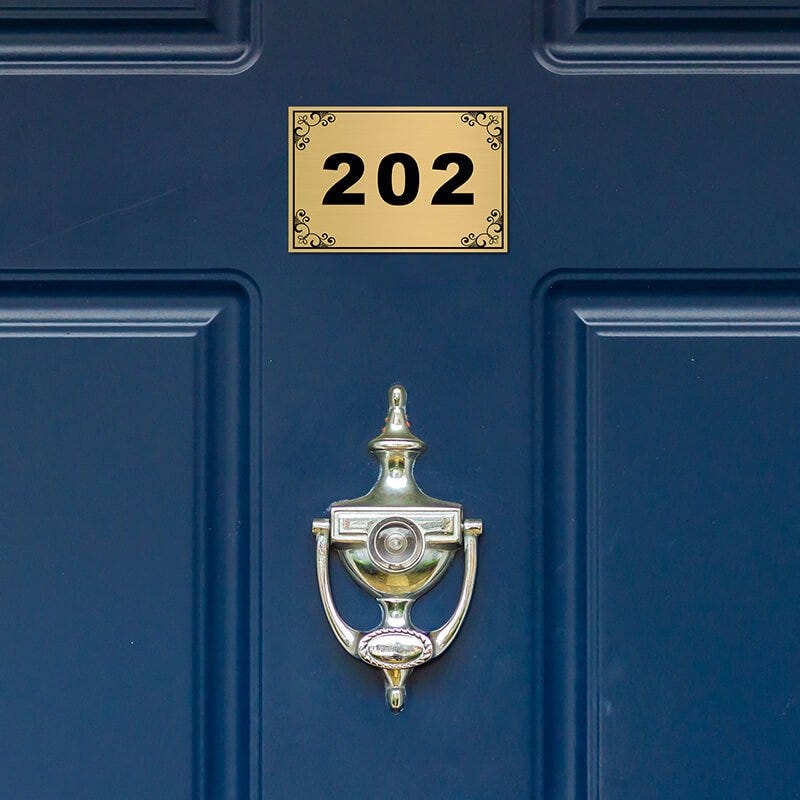 2x3 custom engraved brass sign displayed on a door