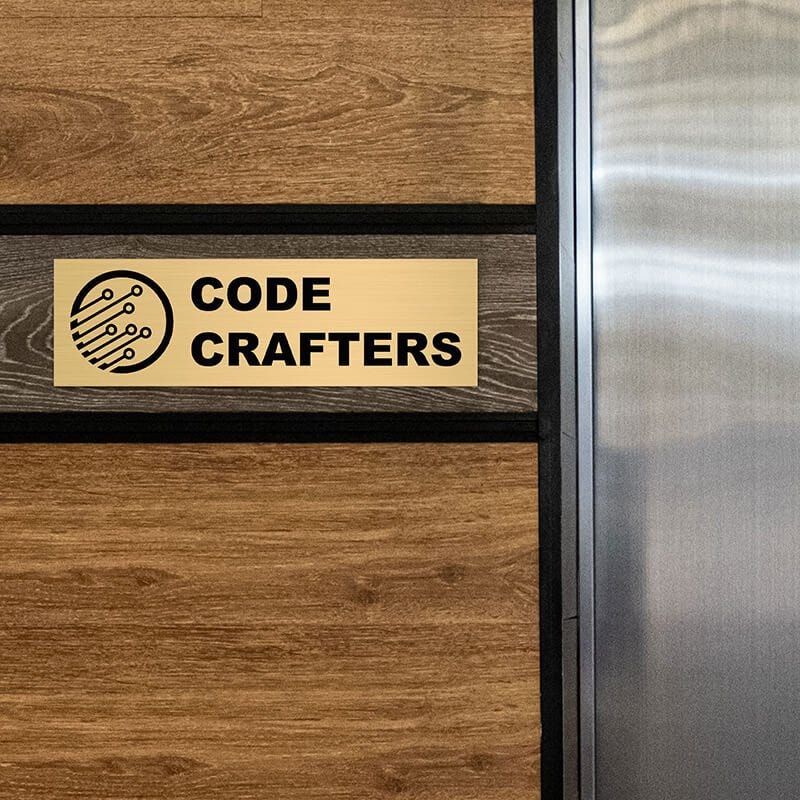 3x10 custom engraved brass sign displayed on a wall