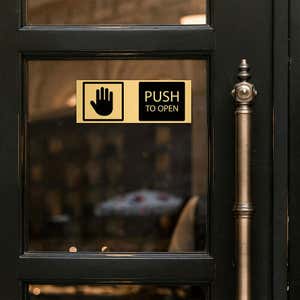 3x8 custom engraved brass sign displayed on a door
