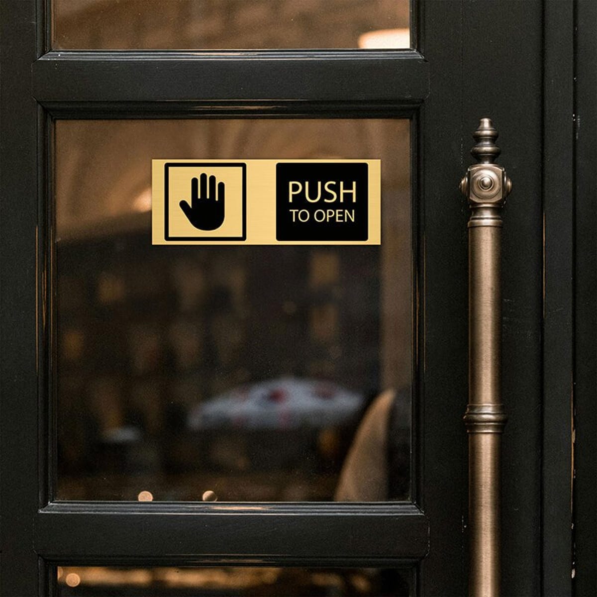 3x8 custom engraved brass sign displayed on a door