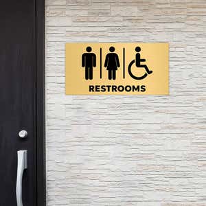 6x12 custom engraved brass sign displayed by a restroom
