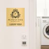 6x6 custom engraved brass sign displayed for a laundry room