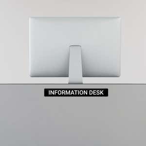 Engraved Sign Horizontal 2" x 16" on an information desk