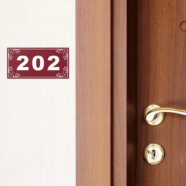 Engraved plastic sign for a room number