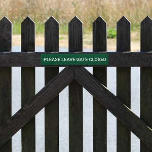 Engraved Sign Horizontal 3" x 18" on a gate