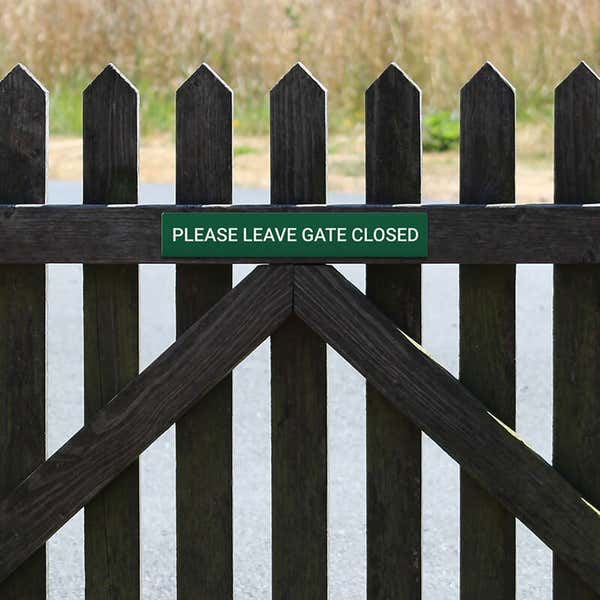 Engraved Sign Horizontal 3" x 18" on a gate