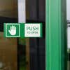 Engraved plastic sign for a push-to-open door