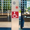 Engraved plastic sign for an accessible entrance 