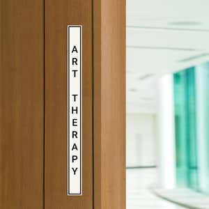 Engraved Sign Vertical 12 in x 1 in on a doorway