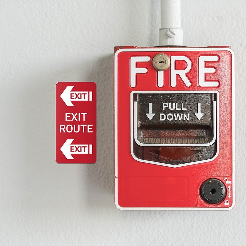 A vertical engraved plastic sign for an exit route A vertical engraved plastic sign for an exit route