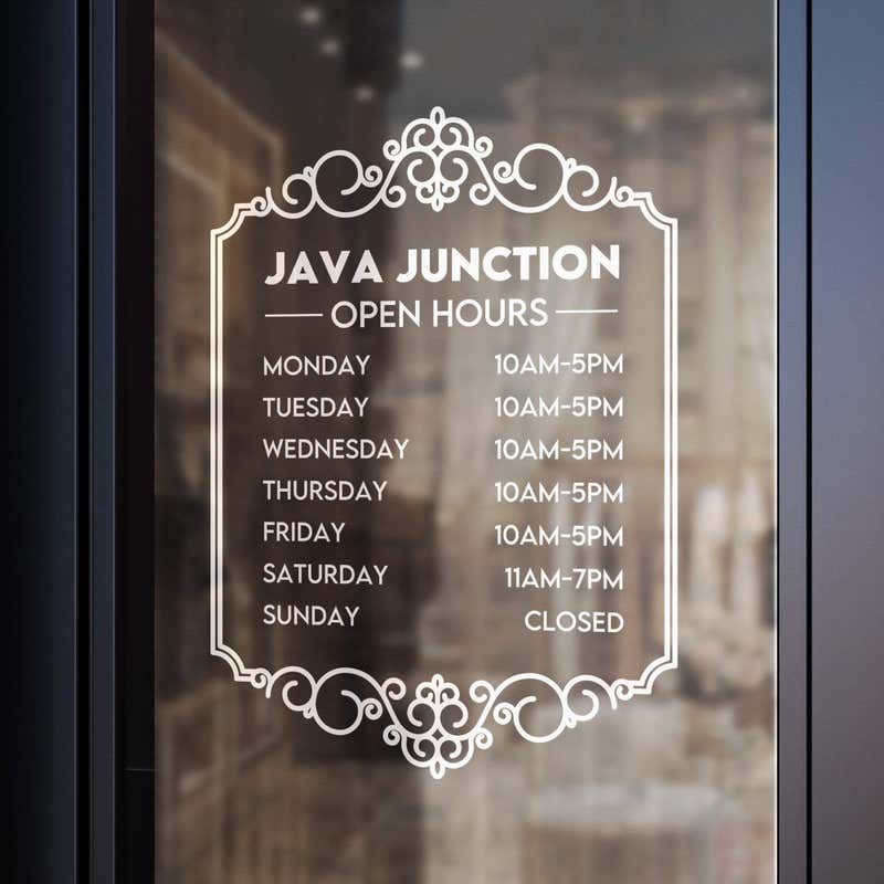 A white business hour decal on a window for a coffee shop