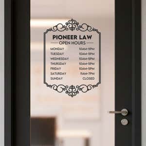 A black business hour decal on a glass door for a lawyers office