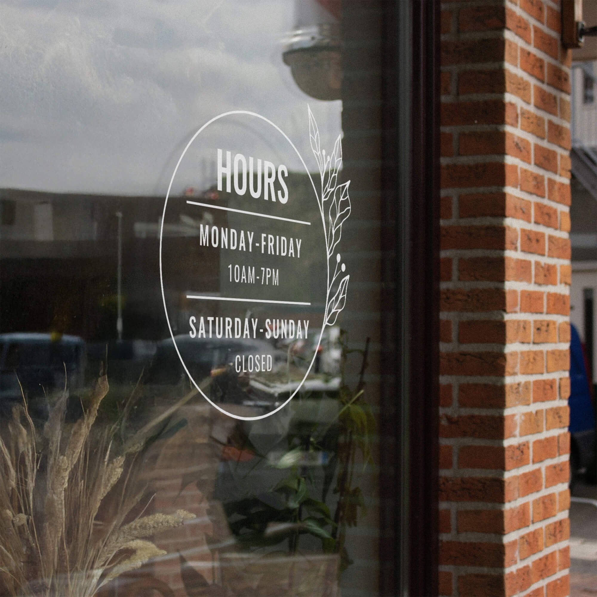 Round business hours decal on a storefront window