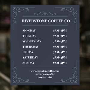 The modern business hour sign on a window for a coffee shop