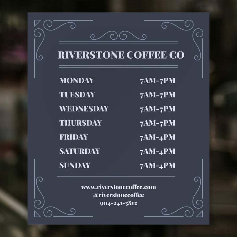 The modern business hour sign on a window for a coffee shop
