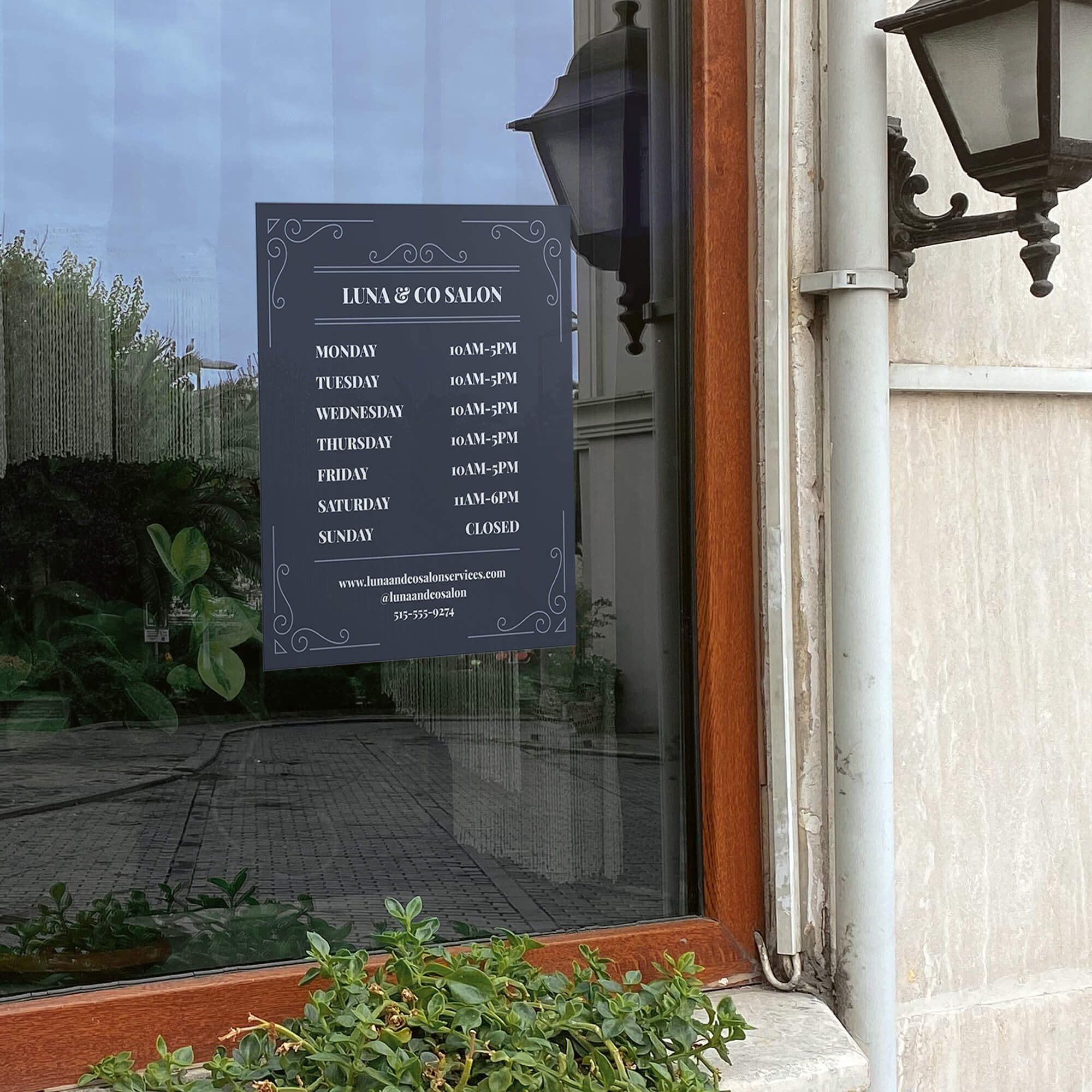 The modern business hour sign on a window for a salon