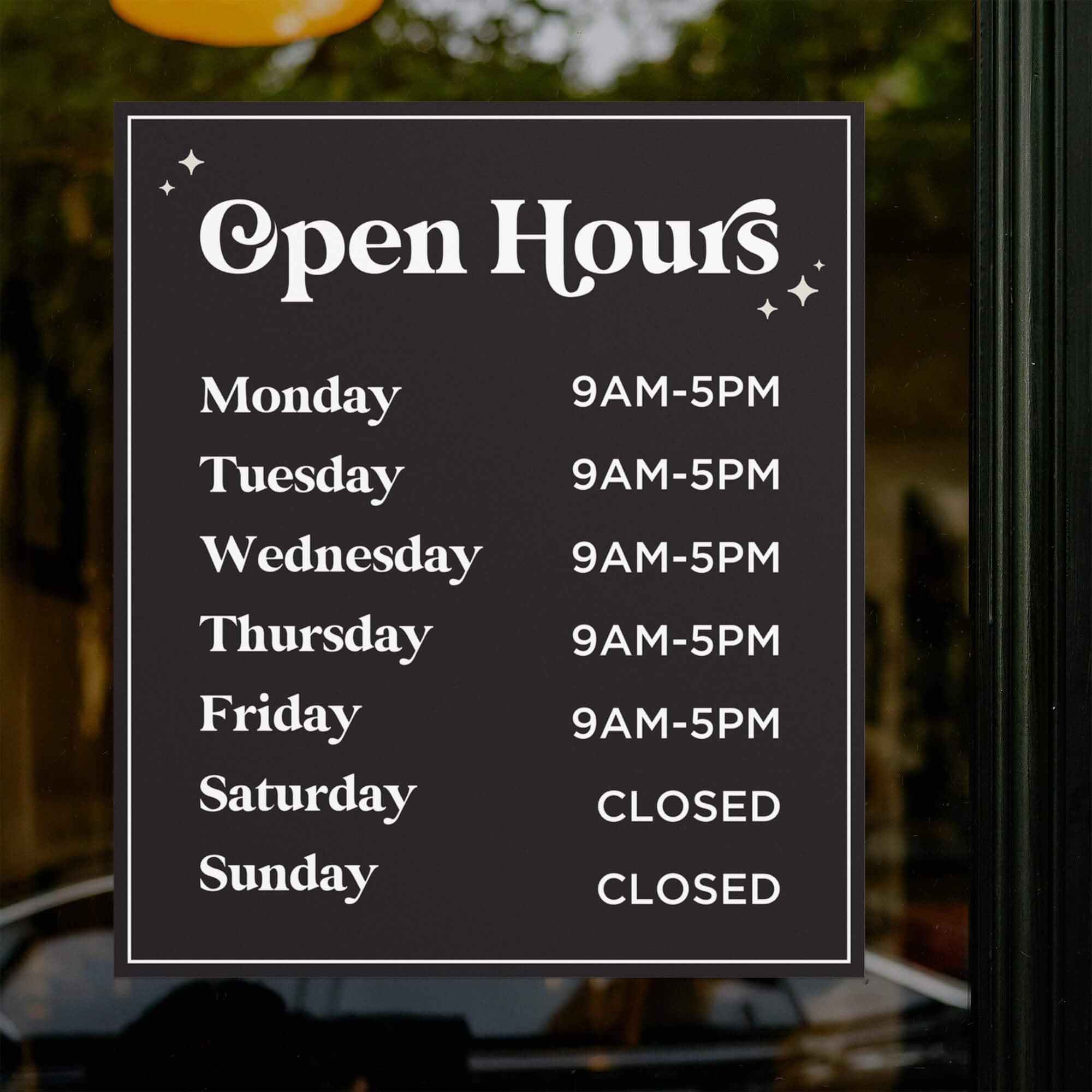 Store hours displayed on the window of a store