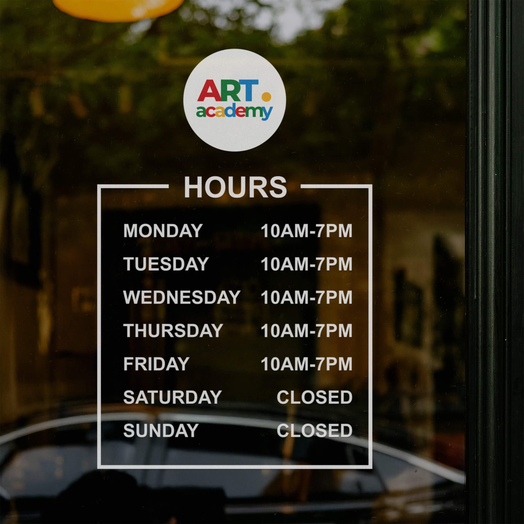 Custom business hours decal on the window of an art academy 
