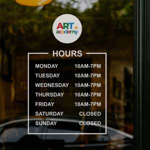 Custom business hours decal on the window of an art academy 
