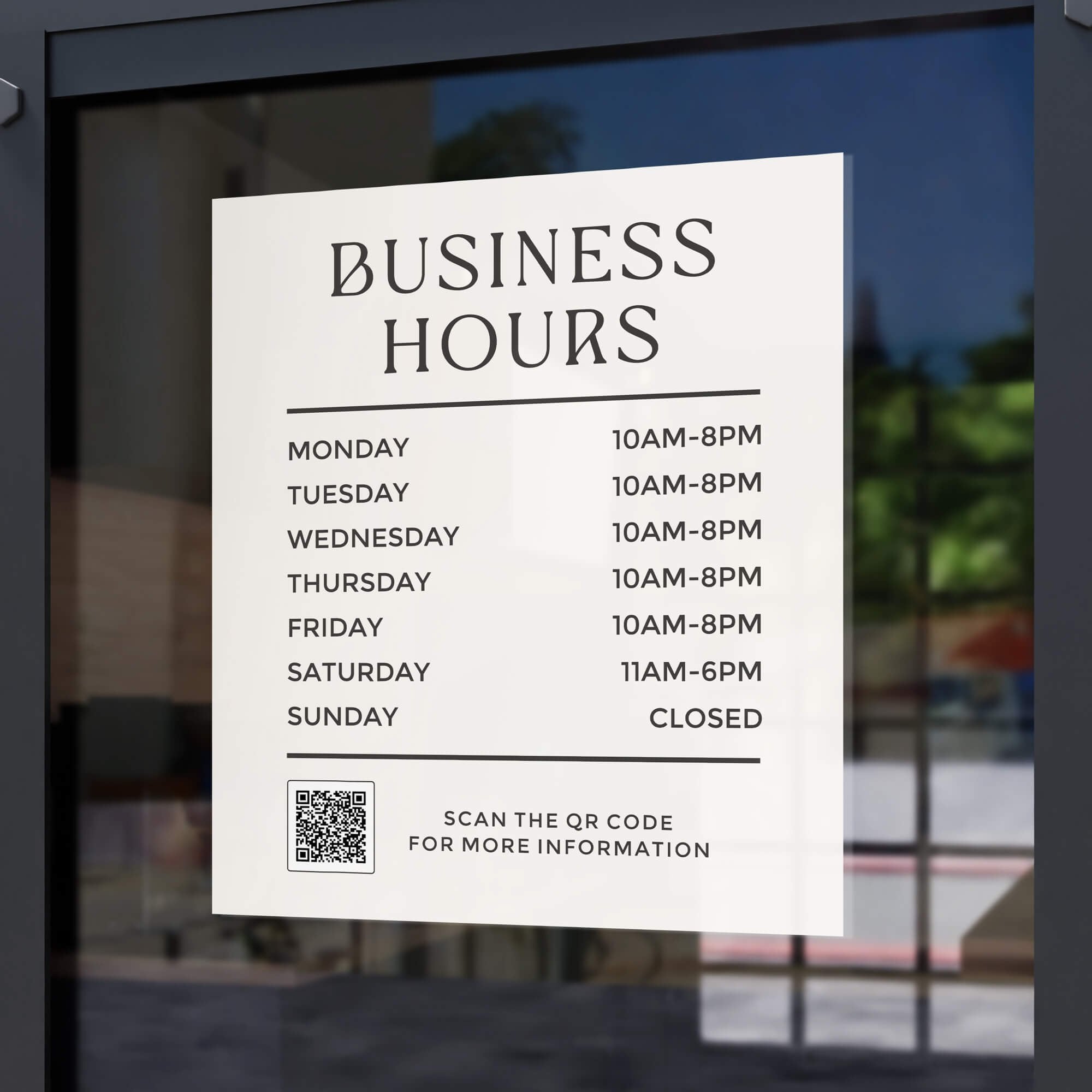 Business hours sign displayed on a store window