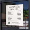Business hours sign displayed on a store window