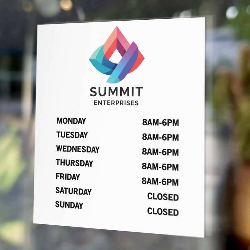 Business hours signs on a window of an office
