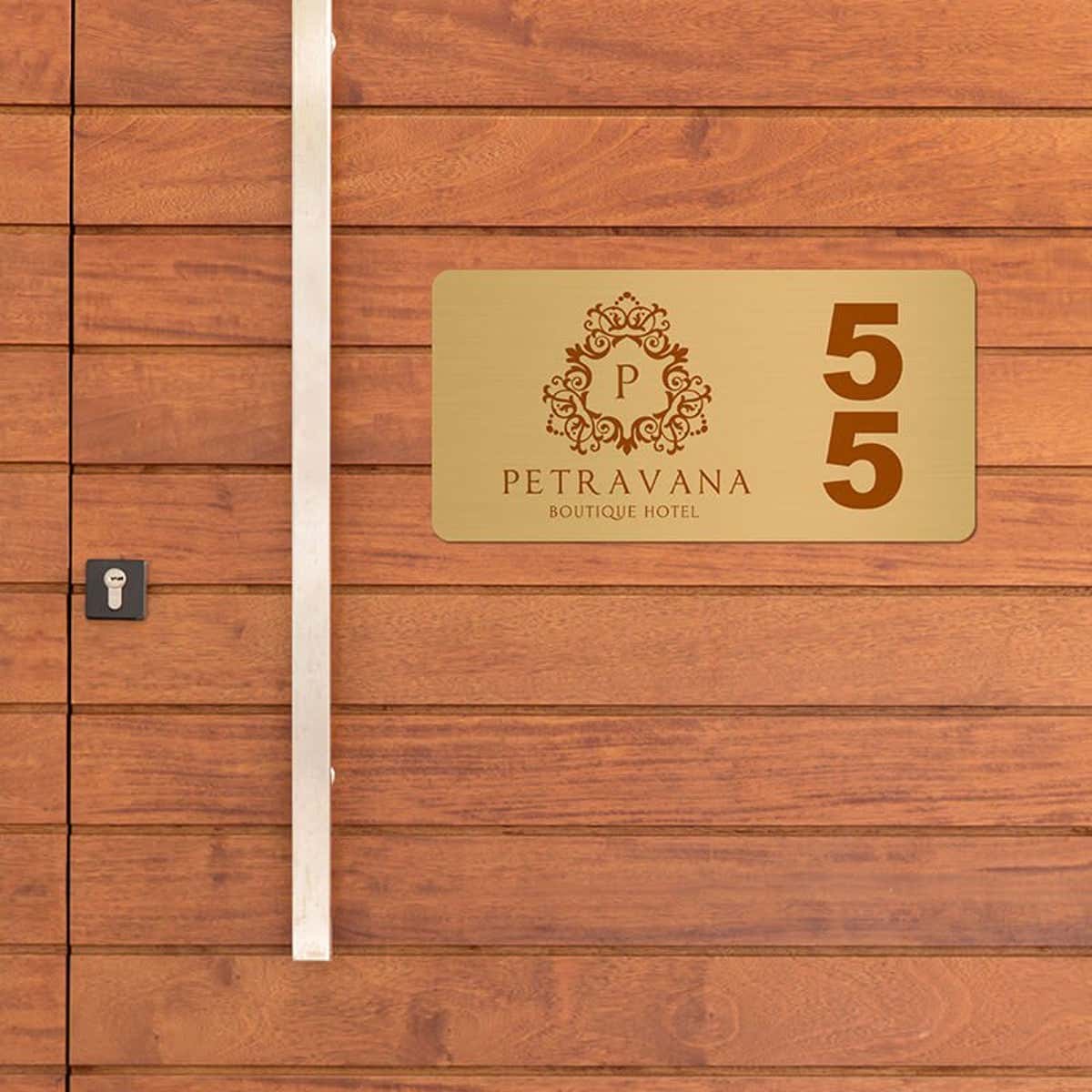 2x4 printed brass sign displayed on a wooden wall